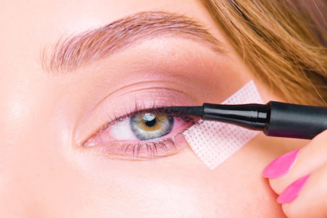 image showing eyeliner being applied with the help of snatched tape