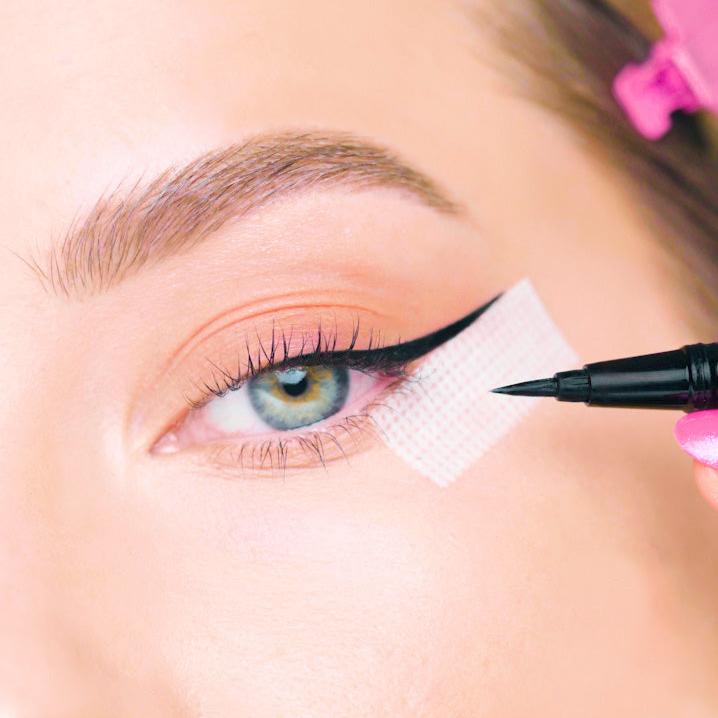 image shows eyeliner being applied with the help of snatched tape